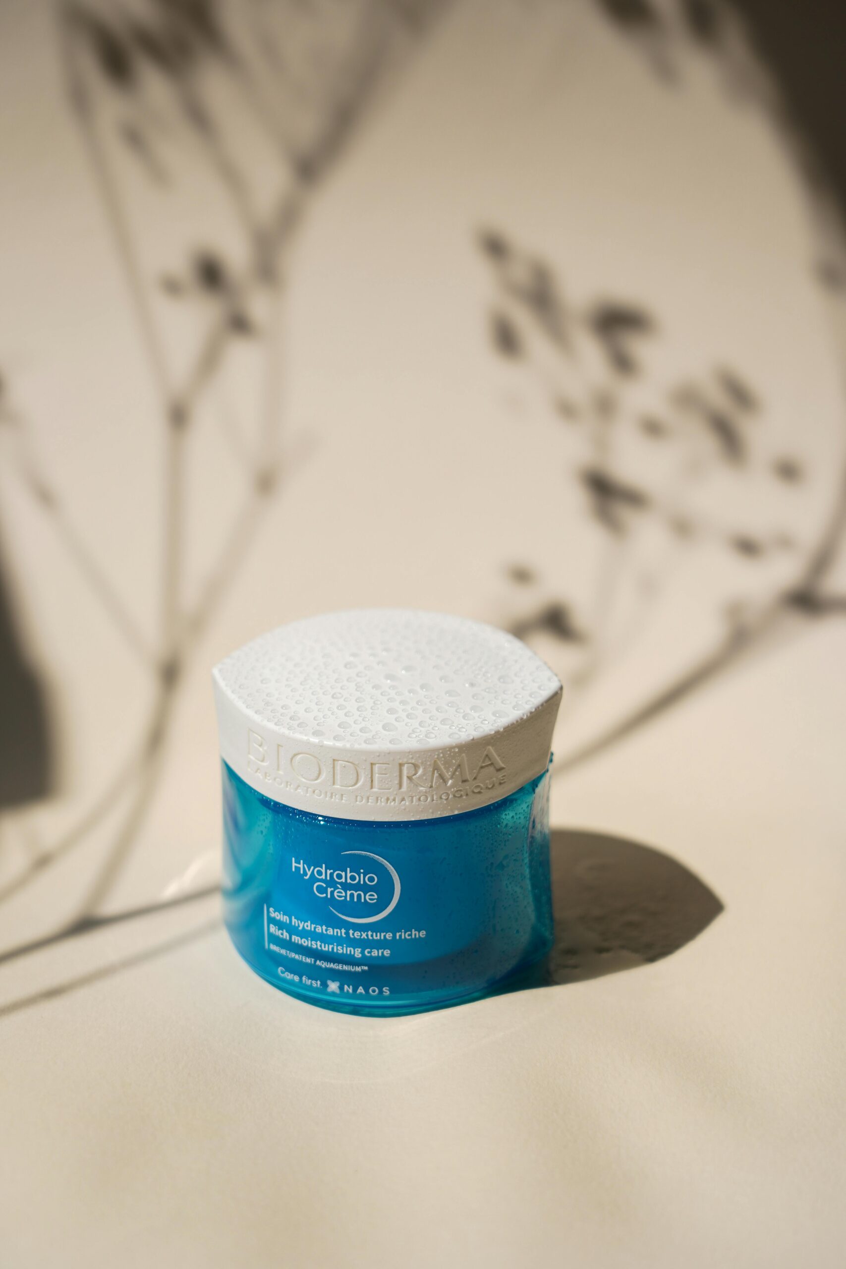 Hydrabio Creme jar with artistic shadows in a soft light setting.