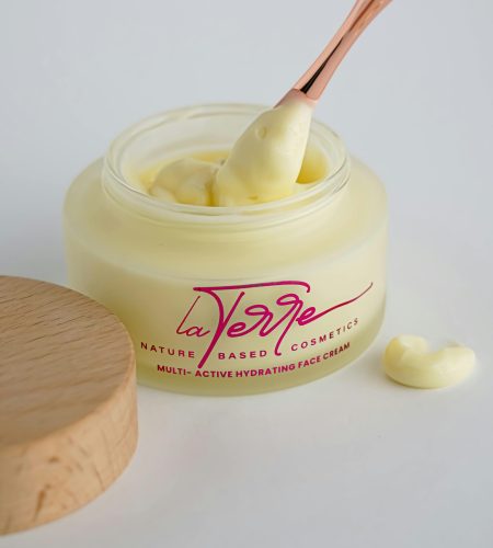 Elegant La Verge face cream with a rose gold applicator for nature-based hydration.